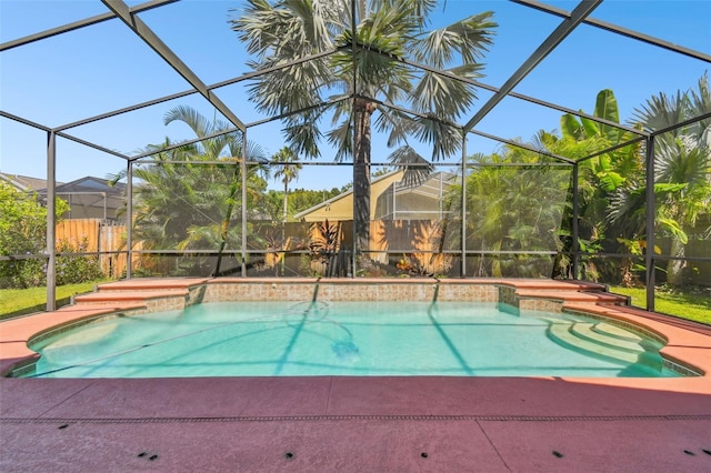 view of swimming pool featuring a lanai and a patio area