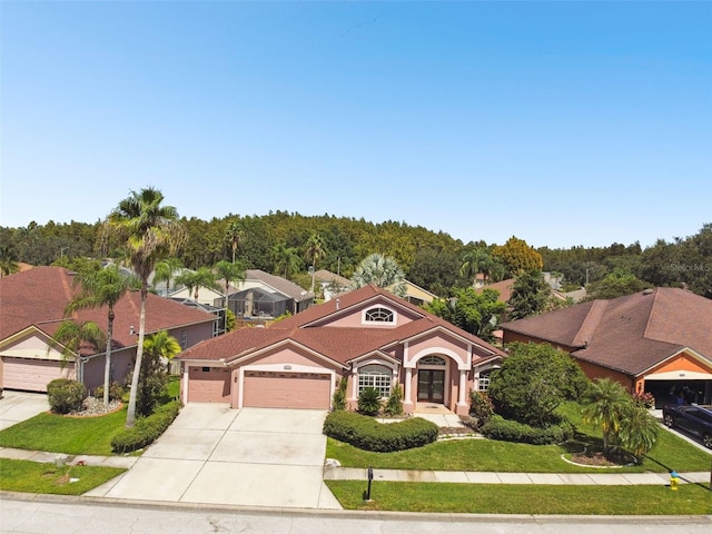 mediterranean / spanish home with a front yard and a garage