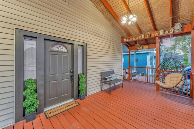 view of exterior entry featuring a wooden deck