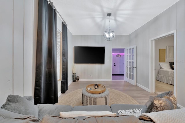 living room with an inviting chandelier and light wood-type flooring