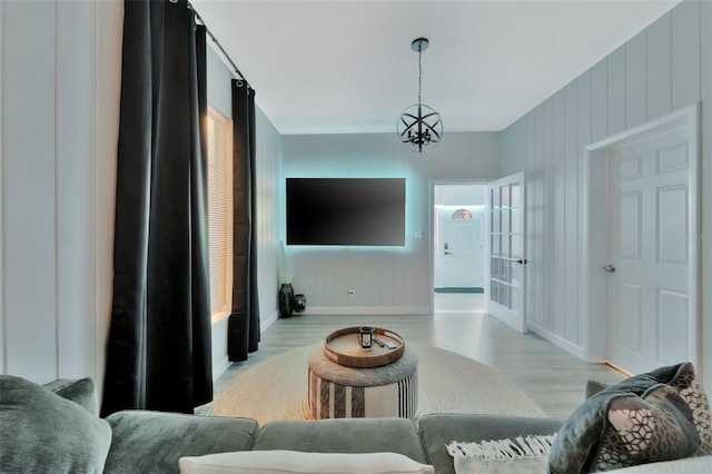 living room with light hardwood / wood-style flooring and a chandelier