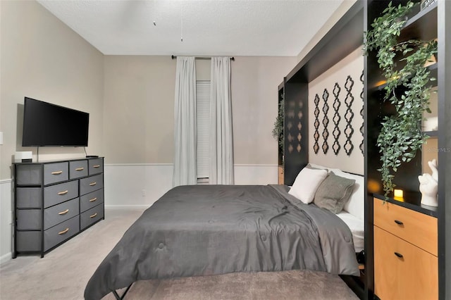 carpeted bedroom featuring a textured ceiling