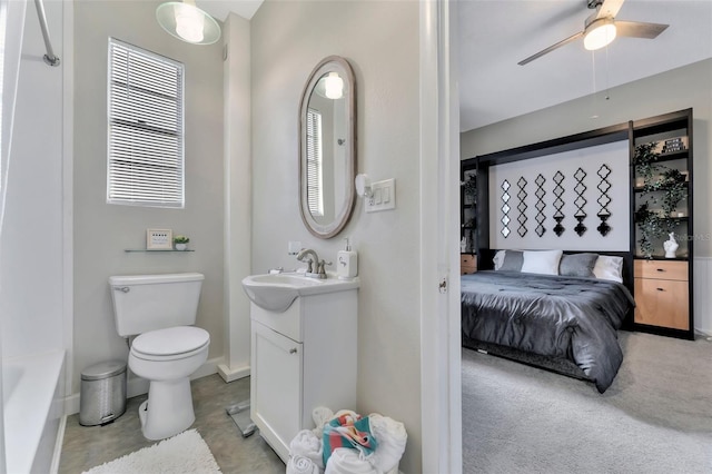 bathroom with vanity, toilet, and ceiling fan