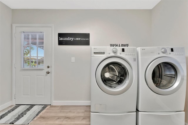 laundry room with separate washer and dryer and light wood-type flooring