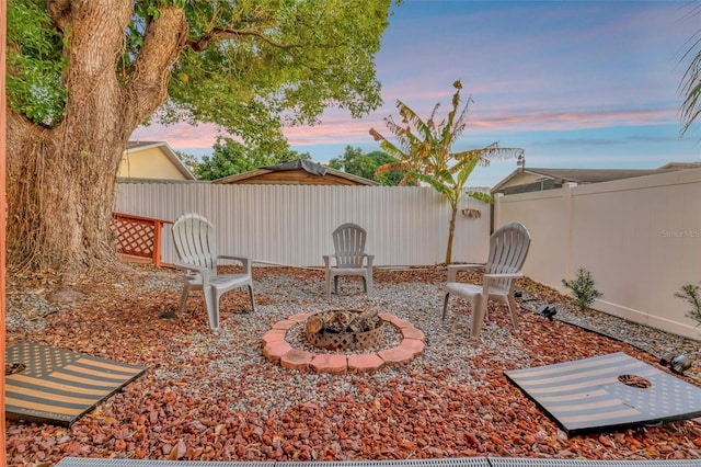 patio terrace at dusk featuring a fire pit