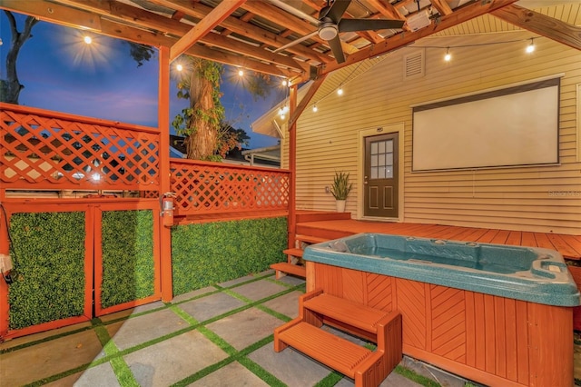 view of patio / terrace with a hot tub and ceiling fan