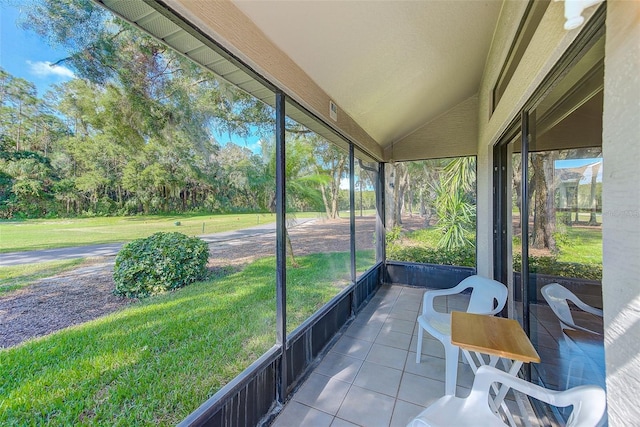 sunroom featuring lofted ceiling