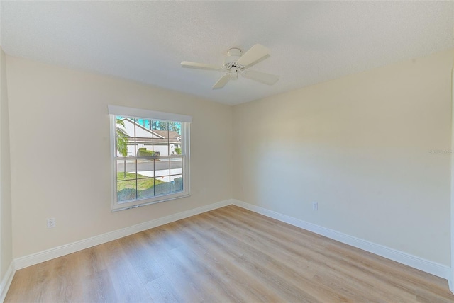 unfurnished room featuring ceiling fan, a textured ceiling, and light wood-type flooring