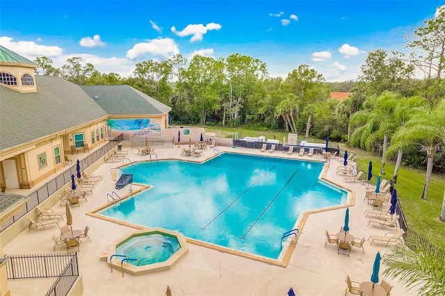 view of swimming pool featuring a patio area and a community hot tub