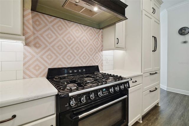 kitchen featuring black range with gas stovetop, extractor fan, dark hardwood / wood-style floors, crown molding, and white cabinetry