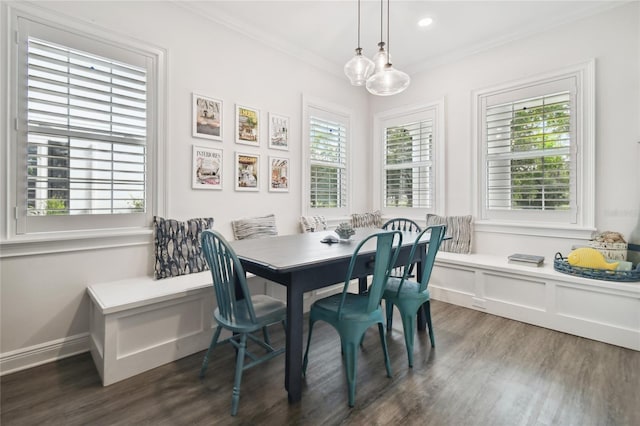 dining area with a wealth of natural light, dark wood-type flooring, and crown molding