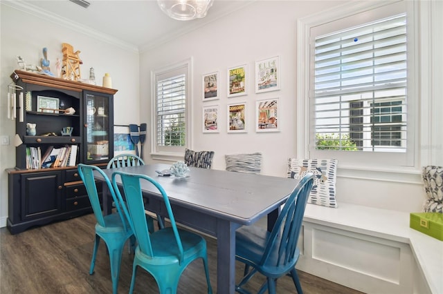 dining area featuring dark wood-type flooring, plenty of natural light, and ornamental molding