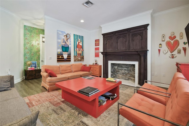 living room with ornamental molding and light hardwood / wood-style floors