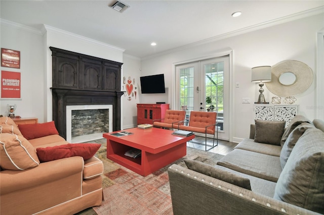 living room featuring french doors, hardwood / wood-style flooring, and crown molding