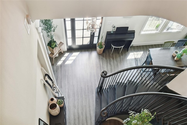 interior space featuring wood-type flooring and an inviting chandelier