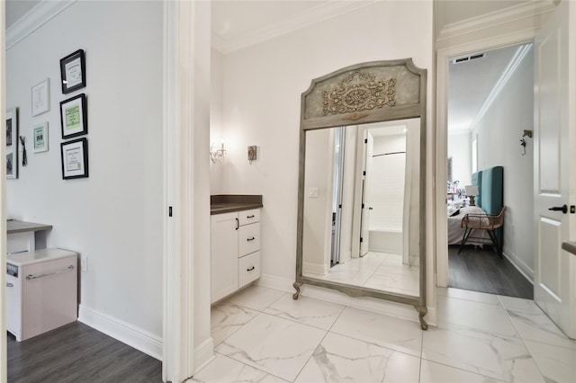 bathroom with ornamental molding, hardwood / wood-style floors, and vanity