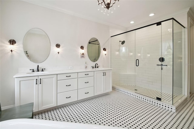 bathroom with an enclosed shower, vanity, and an inviting chandelier