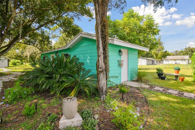 view of outbuilding featuring a lawn