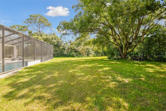 view of yard with glass enclosure