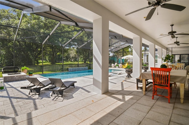 view of patio with glass enclosure, a pool with hot tub, and ceiling fan