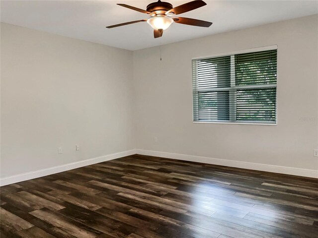 empty room with ceiling fan and dark hardwood / wood-style floors