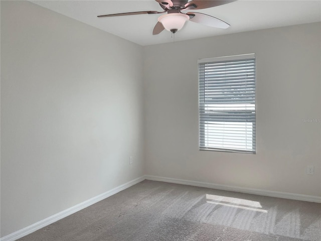 spare room featuring ceiling fan and carpet flooring