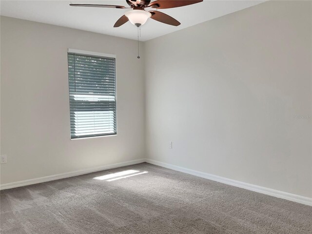 spare room featuring carpet flooring and ceiling fan