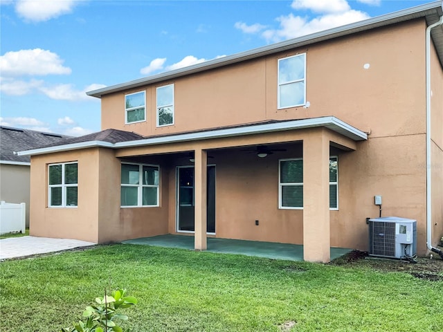 rear view of property featuring central AC unit, a yard, a patio, and ceiling fan