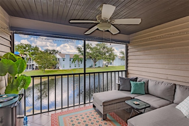 sunroom / solarium with ceiling fan, a water view, and wooden ceiling