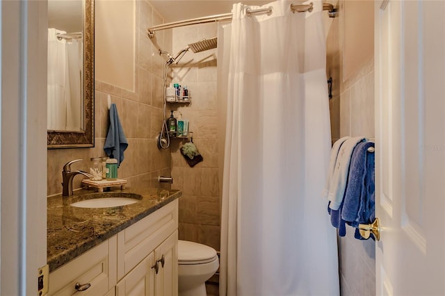 bathroom featuring a shower with curtain, vanity, tile walls, and toilet