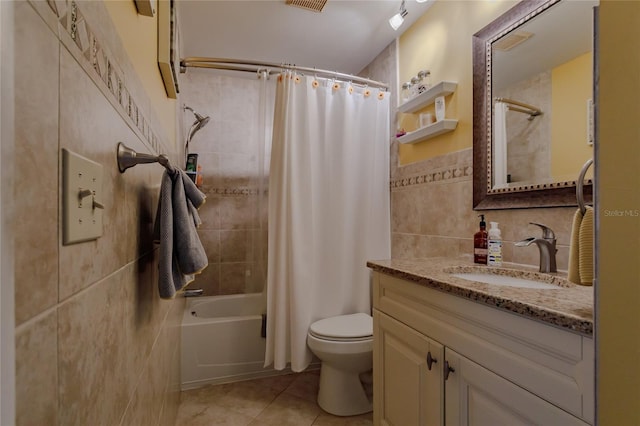 full bathroom featuring vanity, tile patterned flooring, toilet, shower / bath combo with shower curtain, and tile walls