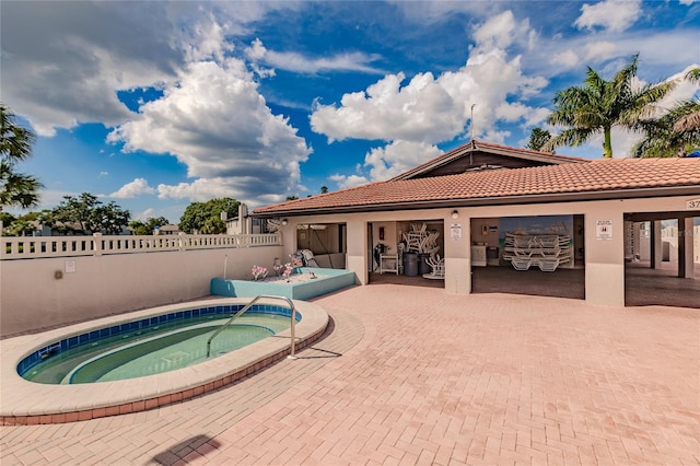 view of pool with a patio and a hot tub