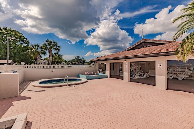 view of pool with a hot tub and a patio area