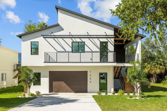 contemporary home with a balcony, a front lawn, and a garage