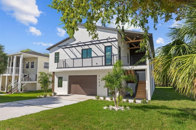 view of front of home with a garage and a front lawn