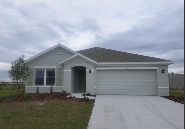 ranch-style home with a garage and a front lawn