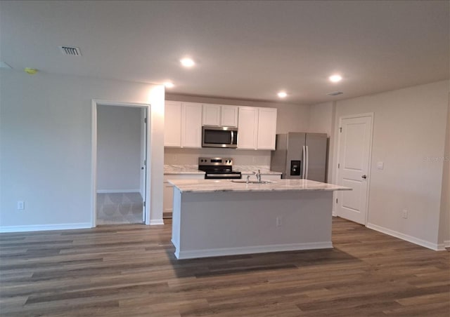 kitchen featuring appliances with stainless steel finishes, dark hardwood / wood-style flooring, white cabinets, and a kitchen island with sink