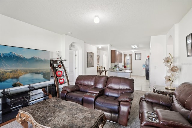 living room featuring a textured ceiling and light carpet