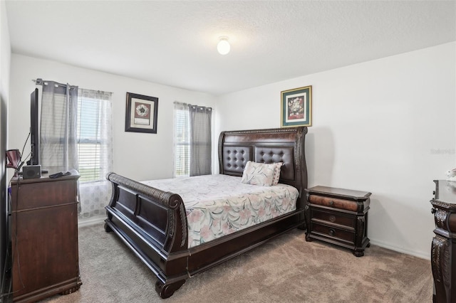 carpeted bedroom with a textured ceiling