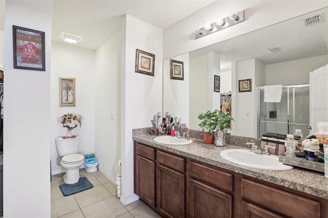 bathroom featuring vanity, tile patterned flooring, an enclosed shower, and toilet