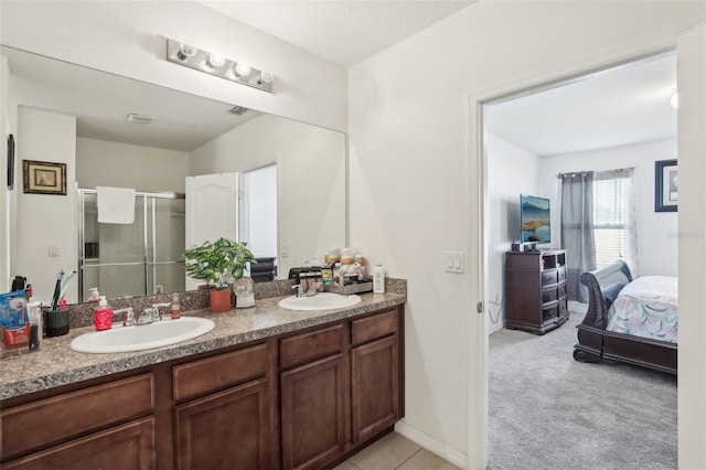 bathroom with a shower with door and vanity