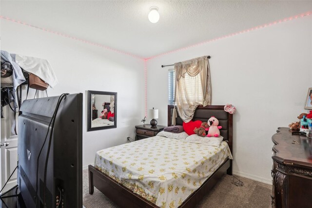 carpeted bedroom with a textured ceiling