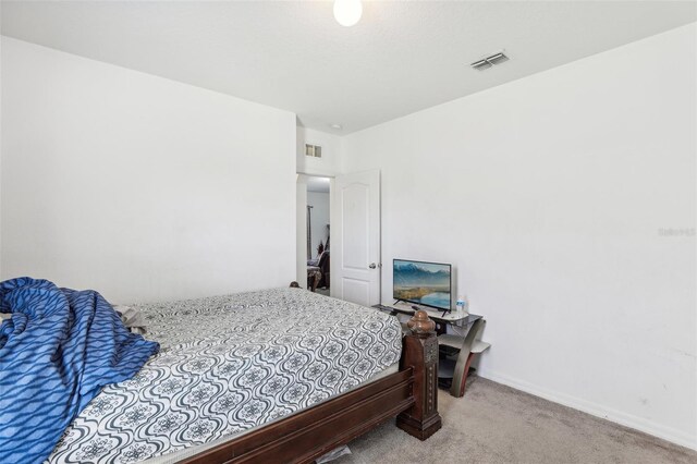 bedroom featuring light colored carpet