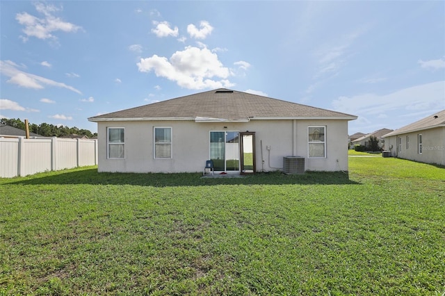 back of house with a lawn