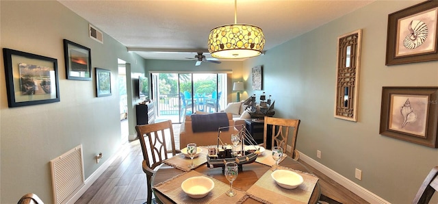 dining room with wood-type flooring and ceiling fan