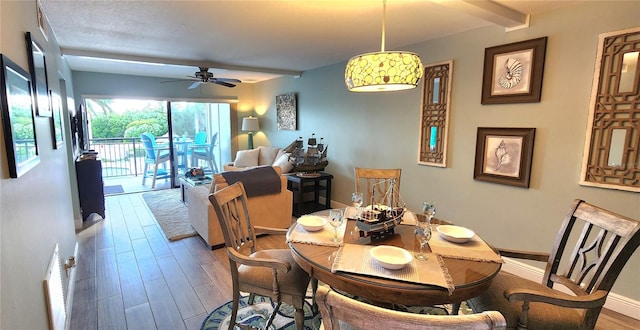 dining space with wood-type flooring and ceiling fan