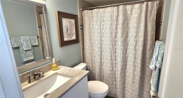 bathroom featuring vanity, toilet, and a shower with shower curtain