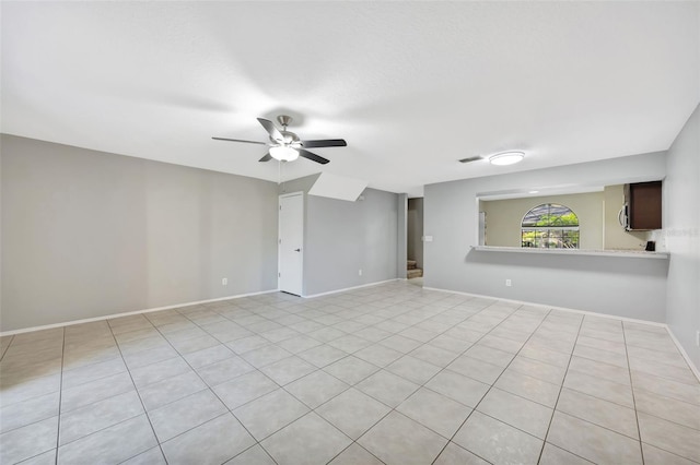 empty room featuring light tile patterned flooring and ceiling fan