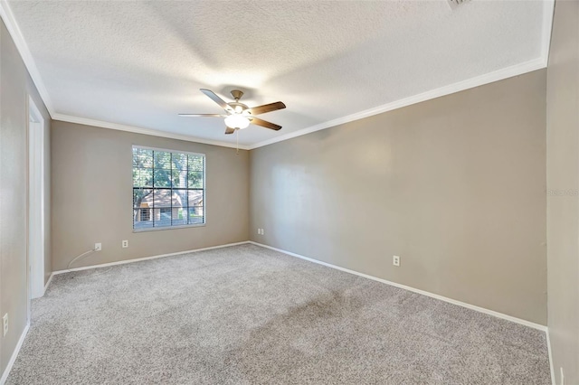 carpeted spare room with ceiling fan, a textured ceiling, and crown molding