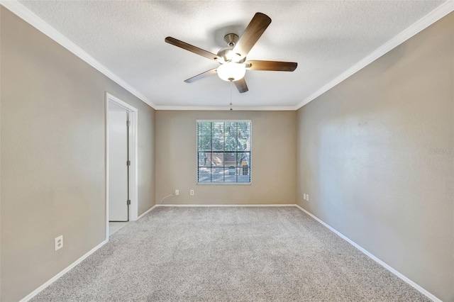 empty room featuring light carpet, ceiling fan, and crown molding